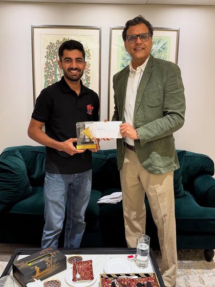 Congratulating a team member on the badminton victory. These activities outside of work build strong bonds.