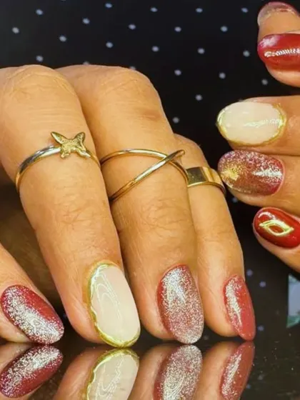 A side view of the multi-finish manicure, showing the combination of glitter, cream, and metallic-outlined nails.
