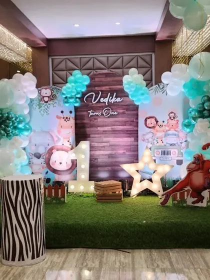 This cute safari theme for Vedika's first birthday uses softer pastel colors and adorable cartoon animal cutouts, creating a friendly and welcoming jungle for the little ones.