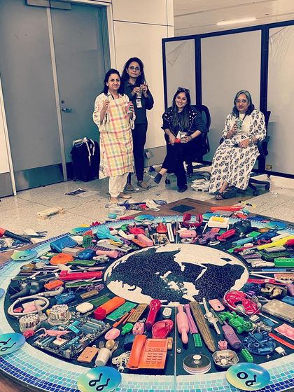 My amazing team of women artists taking a moment with the mural during its creation. This project was a true collaboration, fueled by a shared passion for art with a conscience.