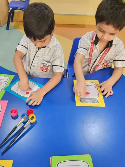 More students participate in the finger painting activity, creating personalized and heartfelt gifts.