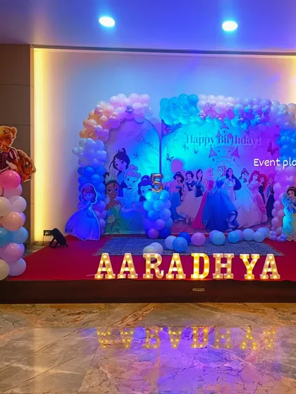 A grand Disney Princess themed 5th birthday party on a large stage.