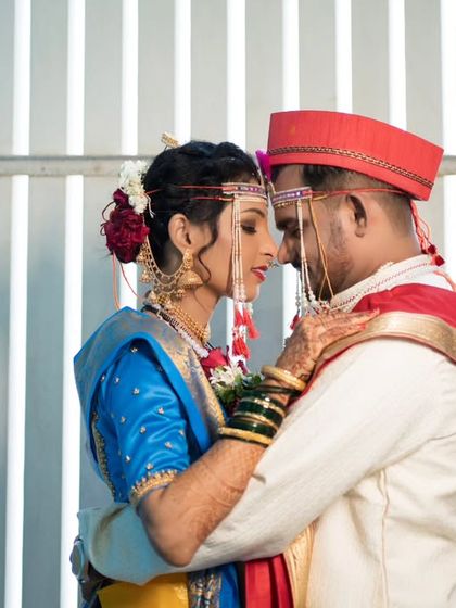 An intimate and artistic portrait against a modern, striped background, highlighting the couple's connection.