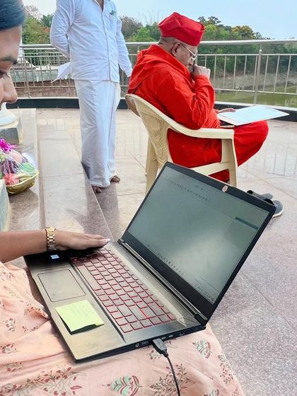 Our architect working on a laptop during an on-site meeting, making real-time adjustments to the design based on the discussion.