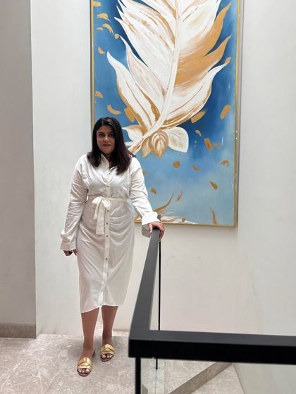 Aishwarya standing on the staircase of a completed project. We built it, designed it, and stressed over it, and now we are admiring it like a proud parent.