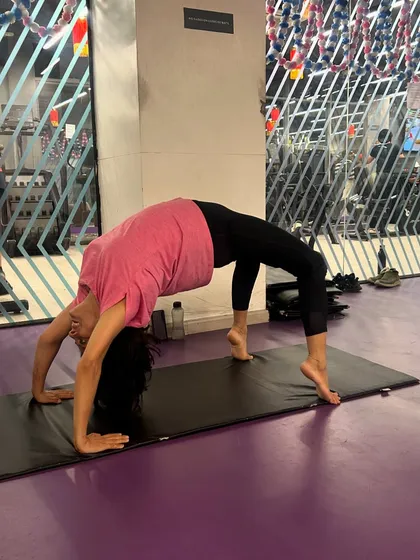 A student in Urdhva Dhanurasana (Wheel Pose) during a gym session. I encourage students to listen to their bodies while exploring their flexibility and strength.