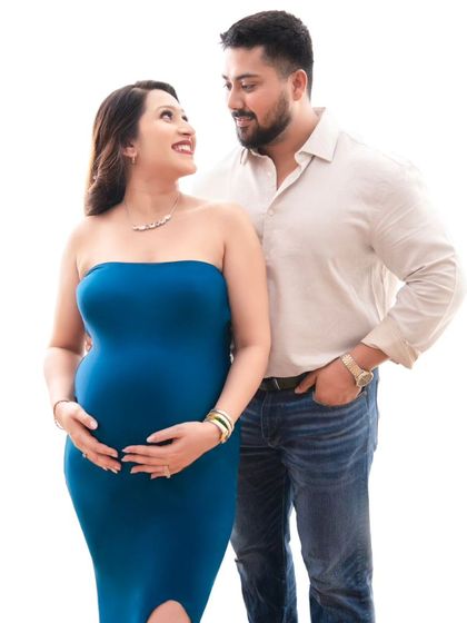 A beautiful portrait of the couple looking at each other with love and admiration. The simple, bright background keeps the focus entirely on their connection.