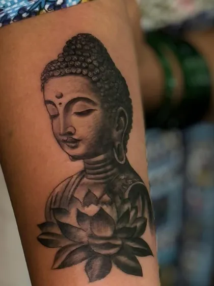 A detailed look at the serene expression on this Buddha portrait tattoo. Getting the facial features right is the most important part of our process.