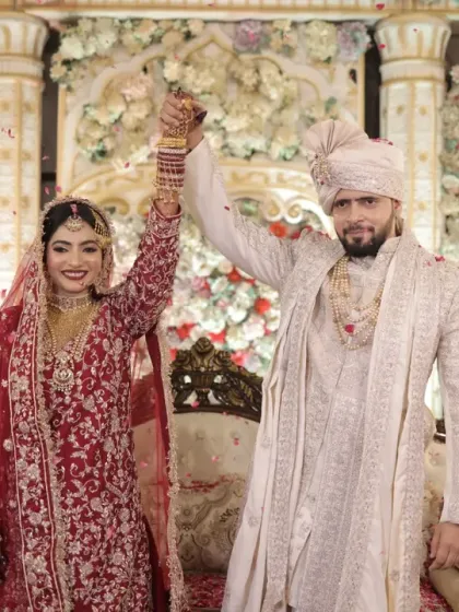 A triumphant moment after the Nikah. The couple raises their hands in celebration, a joyful and iconic shot for any wedding album.