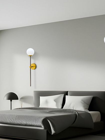 This simple and elegant wall sconce with a globe light is perfect for a modern bedroom. Using one on each side of the bed creates a balanced and sophisticated look.