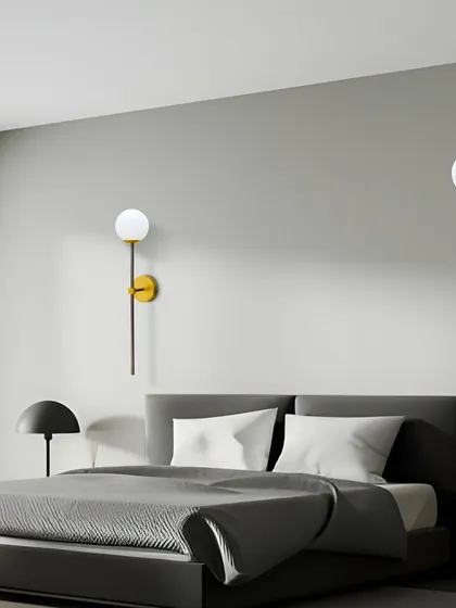 This simple and elegant wall sconce with a globe light is perfect for a modern bedroom. Using one on each side of the bed creates a balanced and sophisticated look.