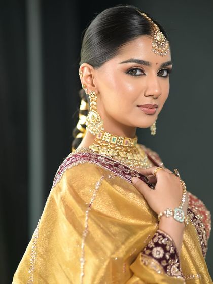 A portrait of our bride, showcasing the clean, pulled-back hairstyle and the perfectly balanced makeup. This look is the epitome of modern bridal elegance.