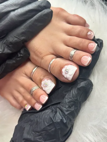 Your toes deserve some love too! This is a close-up of a French pedicure with a gorgeous 3D flower and rhinestone accent on the big toe. It's the perfect finishing touch.