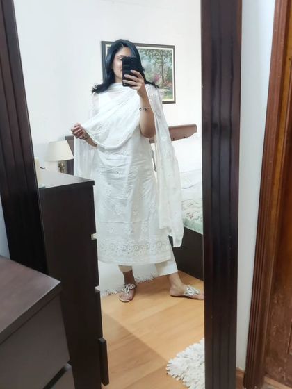 A mirror selfie showing the full white-on-white embroidered kurta, pants, and dupatta. This classic combination is a must-have for chic summer styling.