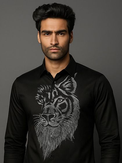 A detailed portrait shot focusing on the magnificent lion embroidery. The silver thread catches the light, highlighting the texture and artistry of the handwork.
