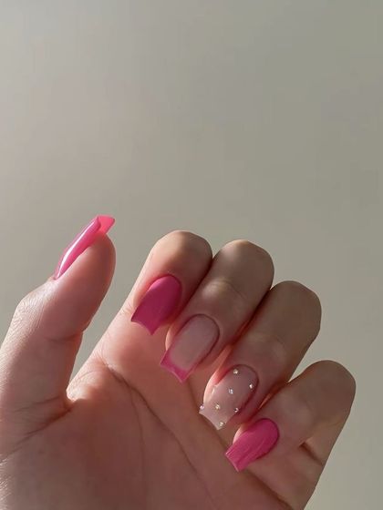 A fun and modern pink set with a French tip and a dotted accent nail.