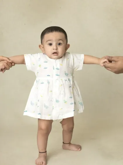 A simple and sweet portrait of a baby taking their first steps. Sometimes, no props are needed to capture a perfect, pure expression.