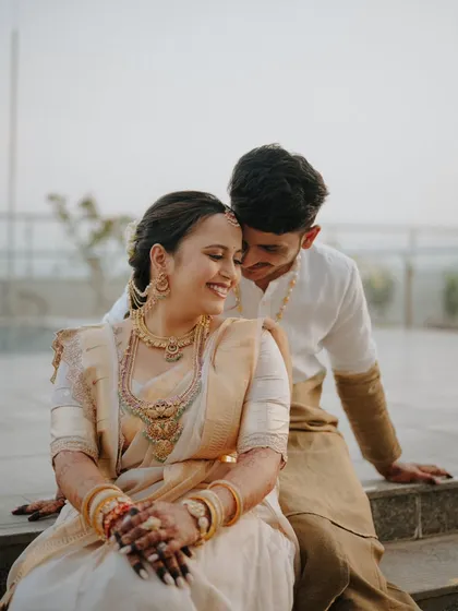 A joyful and intimate close-up. The bride's happy smile and the groom's gentle embrace make this a heartwarming portrait that perfectly captures their chemistry.