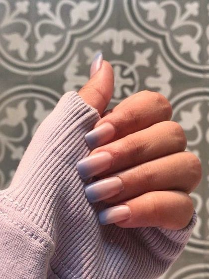 A beautiful square-shaped manicure with a soft blue to nude ombre effect. The subtle gradient of color provides a unique twist on a minimalist look.