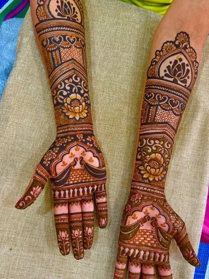 A graceful design featuring lotus and peacock motifs. The use of negative space makes the central flowers and birds stand out, creating a very elegant and artistic look.