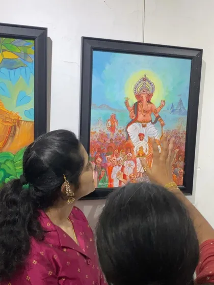 Visitors admiring a detailed Ganesha painting at the Chitrakar Art Exhibition. It's a platform for our artists to display their work to an appreciative audience.