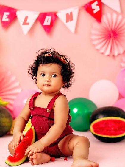 A close-up of our 'one in a melon' star. The bright colors and fresh watermelons make for a unique and vibrant first birthday session.