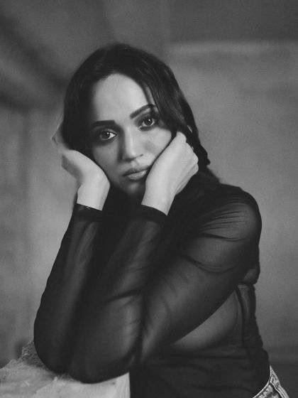 A close-up from the 'Monochrome Mood' series. The soft lighting and direct gaze create a soulful and intimate black and white portrait, perfect for a model's portfolio.