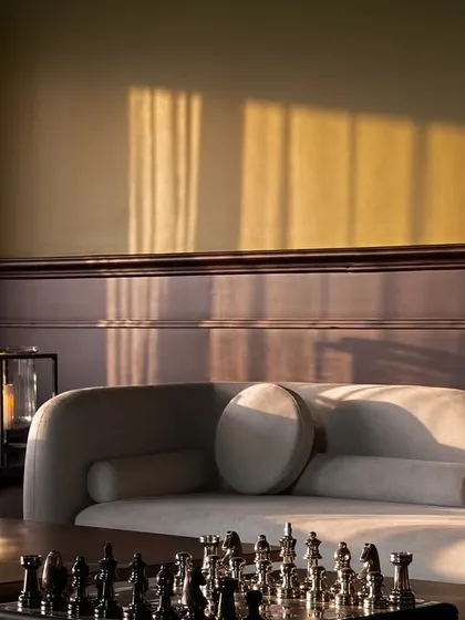The way light falls in a room is one of my obsessions. This moment captures the warm evening sun highlighting the textures of the sofa and the rich teak wood, creating a quiet, contemplative mood that I strive for in my designs.