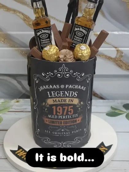 Celebrating a legend? This cake is for them. Designed for a 50th birthday, this "Legends Made in 1975" cake is topped with miniature Jack Daniel's bottles, Ferrero Rocher, and KitKats. It’s a bold and fun design perfect for milestone adult birthdays.