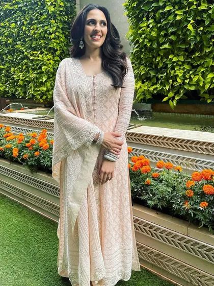 A beautiful and serene look in a light pink chikankari suit. The delicate embroidery and soft color make it a perfect choice for a daytime event or a puja.