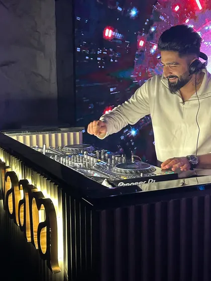 A smile on my face because I'm doing what I love. Here I am behind the illuminated console at R-Adda, completely absorbed in the mix.