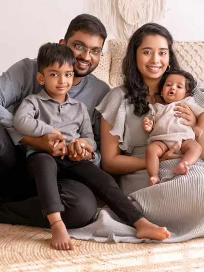 When little ones become your world. This beautiful family portrait captures the love and connection between parents and their two children.