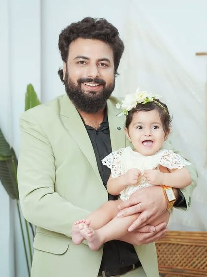 A proud father holding his happy baby girl. We capture both posed and candid moments to give you a full gallery of memories.