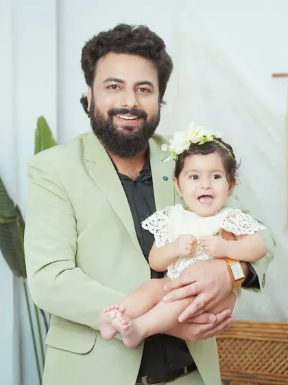 A proud father holding his happy baby girl. We capture both posed and candid moments to give you a full gallery of memories.