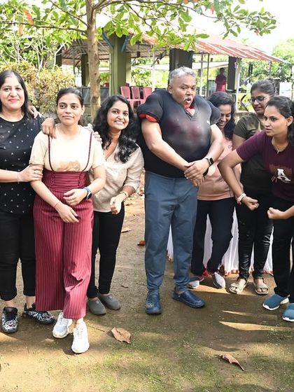A team posing for a group photo after a fun-filled day of activities. It's all about building camaraderie and ending the day with a stronger sense of connection.
