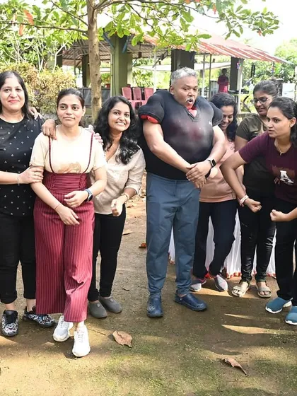 A team posing for a group photo after a fun-filled day of activities. It's all about building camaraderie and ending the day with a stronger sense of connection.