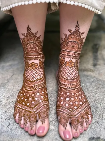 A classic full coverage bridal foot design with beautiful symmetry and a mix of floral and geometric patterns.