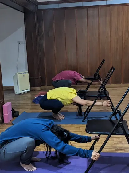 Finding happiness in everyday moments, like this Monday class using chairs for a supported squat stretch. It's about finding joy in the simple things.