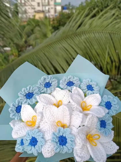 A close-up of the blue and white custom bouquet.