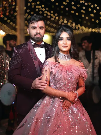 A beautiful portrait of the couple. The warm lighting and the festive background create a perfect setting for this glamorous engagement party.
