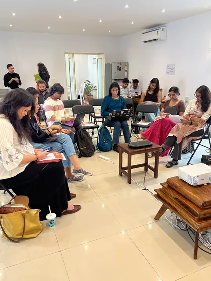 A focused shot of our 'Verse & Voice' workshop in session. We create a studious yet comfortable atmosphere for deep learning and creative exploration.