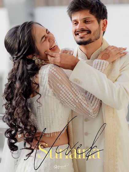 A joyful and candid portrait of the couple, beautifully signed with their names, making for a perfect engagement announcement photo.