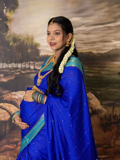 A candid moment of happiness. This side-profile shot captures a natural smile, showing the joy and anticipation of motherhood in a traditional setting.