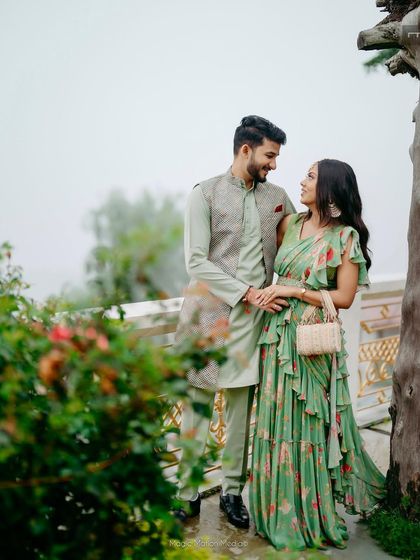 A lovely couple portrait from a Mehendi event in the mountains. The bride's green floral saree is paired with a natural makeup look, perfect for the misty, romantic setting.