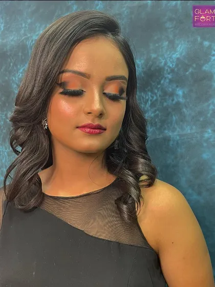 A soft and romantic party look. The warm-toned eyeshadow and soft waves in the hair create a beautiful and approachable style.