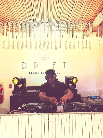 On the decks at Drift Beach Bar & Grill in Thailand. My international gigs have taught me how to read and rock any crowd, anywhere in the world.