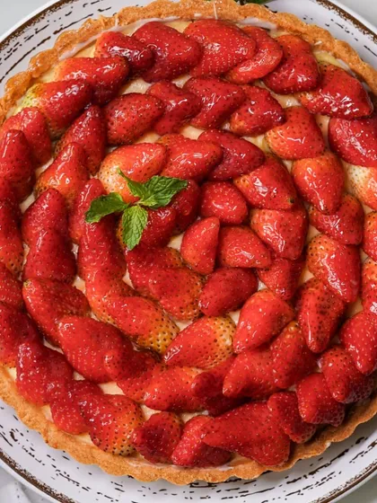 A celebration of the season in our stunning strawberry tart. This dessert features a buttery pastry crust, creamy crème pâtissière, and a beautiful arrangement of fresh, juicy Mahabaleshwar strawberries, making it a perfect centerpiece for any occasion.
