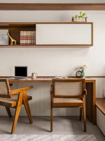 This versatile room in our 'Palaash' project serves as a home office, library, and guest room. The integrated study desk flows into a platform daybed with built-in storage, showcasing our approach to creating multi-functional, adaptable living spaces.