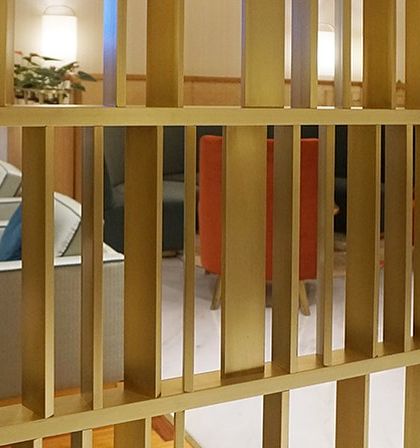 A detail of the custom-designed metal screen partition in the Departure Lounge at Bangalore International Airport. This element was carefully designed to conceal floating columns while adding a decorative, light-filtering feature to the space.