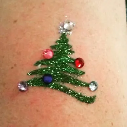 A classic Christmas tree design in green glitter, decorated with colorful gems for extra sparkle. This is a fun and festive option for holiday carnivals and events.